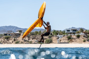 a person riding a surf board on a body of water